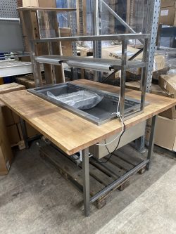 Pizza counter with cooling well and wooden board used